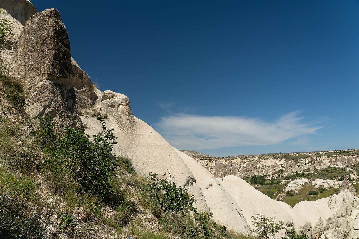 Hikers walking a trail through the rock formations of Cappadocia's Rose Valley